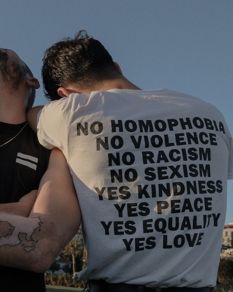Two individuals showcasing an LGBTQ+ equality message in Istanbul for social change.